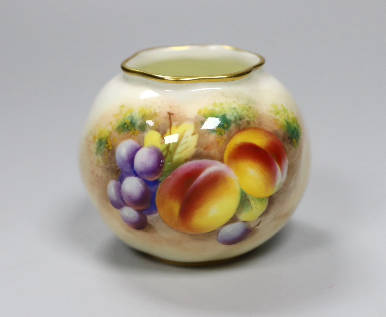 A Royal Worcester spirally moulded globular vase painted with fruits by Roberts, date code for 1955, height 7cm